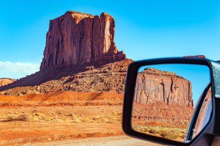 Photo for The car mirror reflects the scenic landscape. The famous colossal rock Camel. Navajo Indian Reservations. USA. Monument Valley is a unique geological formation in Arizona and Utah. - Royalty Free Image