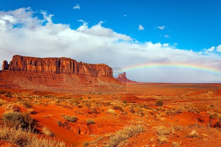 Photo for Navajo Indian Reservations. USA. Monument Valley Sentinel Mesa and the bright rainbow. Monument Valley is a unique geological formation in Arizona and Utah. - Royalty Free Image