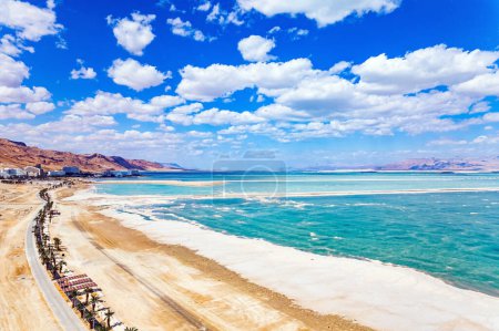 Israel. Magnificent resort for treatment and relaxation. Drone filming. The picturesque embankment is lined with palm trees. The Dead Sea is an endorheic salt lake. 