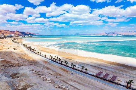Israel. The Dead Sea is an endorheic salt lake. Magnificent resort for treatment and relaxation. Drone filming. The picturesque embankment is lined with palm trees