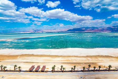 The Dead Sea is an endorheic salt lake. Israel. Magnificent resort for treatment and relaxation. Drone filming. The picturesque embankment is lined with palm trees
