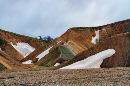 Téléchargez les photos : Landmannalaugar. Montagnes de rhyolite, vestiges de la neige de l'année dernière et coulées de lave solidifiée. Islande incroyable - rêve pour les touristes et les photographes. - en image libre de droit