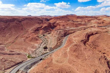 Judean desert on the shores of the Dead Sea. Dry waterless hills of red clay. Excellent highway are laid among the hills. Shooting from a bird's eye view. Israel