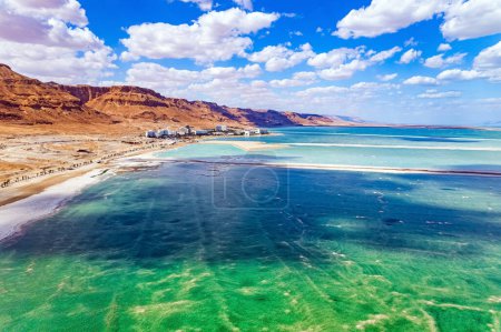 The Dead Sea. Cloud shadows reflected in the water. The evaporated salt is collected on the water. Resort for relaxation and treatment. Israel. Drone filming.