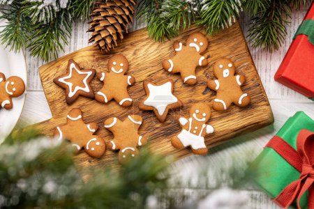Photo for Gingerbread man cookies on wooden board. Christmas holiday gift boxes. Flat lay - Royalty Free Image
