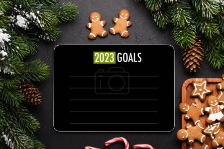 Photo for Tablet with goals list template, gingerbread cookies and Christmas decor. Xmas device screen mockup - Royalty Free Image