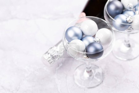 Photo for Champagne bottle, glasses with Christmas bauble balls. With copy space - Royalty Free Image