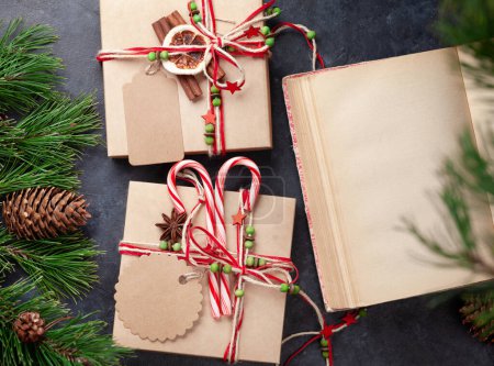 Téléchargez les photos : Coffret cadeau de Noël avec décor artisanal et livre vintage. Top vue plat étendu avec de l'espace pour vos salutations - en image libre de droit