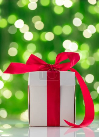 Photo for Christmas gift box in front of Xmas lights bokeh - Royalty Free Image