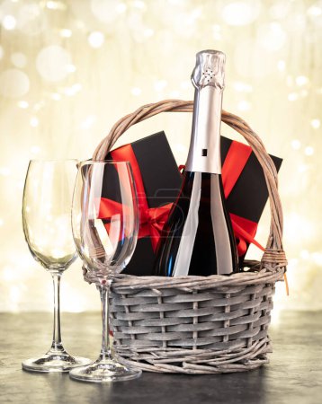 Photo for Basket with Christmas gift boxes and champagne - Royalty Free Image