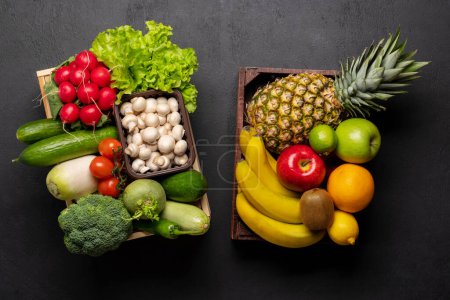 Photo for Wooden boxes full of healthy vegetables and fruits food. Flat lay - Royalty Free Image