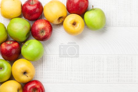 Photo for Colorful ripe apple fruits on wooden table. Top view flat lay with copy space - Royalty Free Image