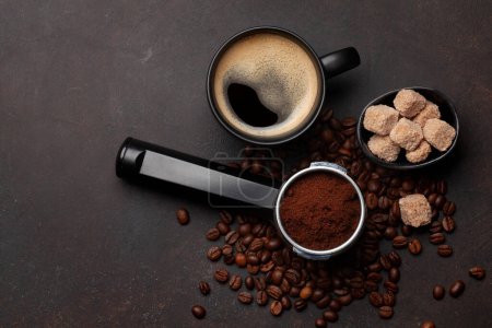 Photo for Roasted coffee beans, ground coffee in filter holder and espresso cup. Top view flat lay with copy space - Royalty Free Image