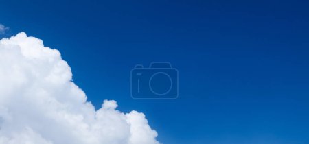 Photo for Blue sunny sky with clouds and copy space in center - Royalty Free Image
