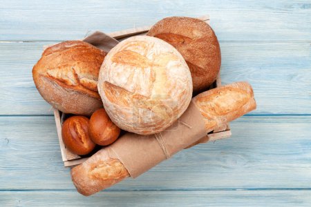 Photo for Various types of bread on wooden table. Top view flat lay - Royalty Free Image