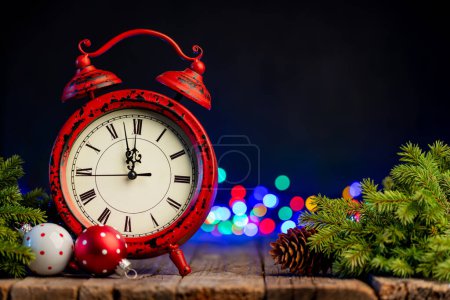 Photo for Christmas clock, tree branch with decor and garland bokeh - Royalty Free Image