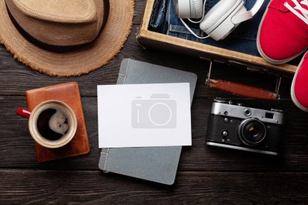 Photo for Travel and vacation concept. Trip accessories and items. Coffee cup, blank card and camera. Top view flat lay with space for your travel notes or photo - Royalty Free Image