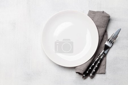 Photo for Empty plate and silverware on stone table. Top view flat lay with copy space. Template or mockup for your meal - Royalty Free Image