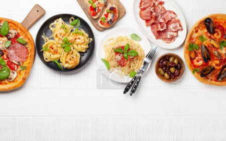 Photo for Italian cuisine. Pasta, pizza, olives and antipasto toasts. Flat lay with copy space - Royalty Free Image