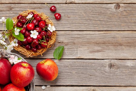 Photo for Ripe red apples and cherry on wooden table. Top view flat lay with copy space - Royalty Free Image
