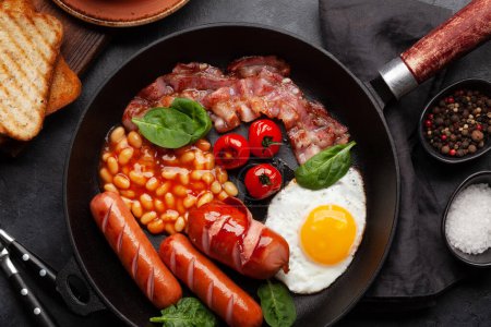 Photo for English breakfast with fried eggs, beans, bacon and sausages. Top view flat lay - Royalty Free Image
