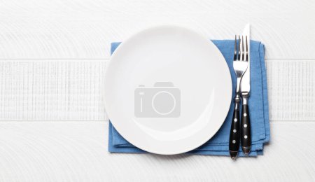 Photo for Empty plate and silverware on wooden table. Top view flat lay with copy space. Template or mockup for your meal - Royalty Free Image