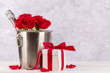 Foto de Tarjeta de San Valentín con champán, flores de rosas y caja de regalo. Con espacio para tus saludos - Imagen libre de derechos
