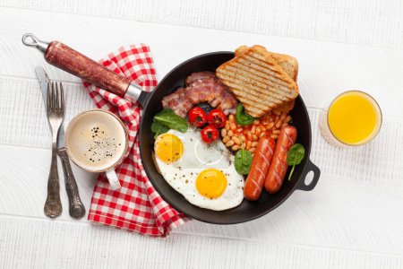 Photo for English breakfast with fried eggs, beans, bacon and sausages. Top view flat lay with coffee and orange juice - Royalty Free Image