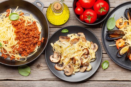 Photo for Various Italian pasta. Seafood, mushroom and tomato sauce pasta, spaghetti bolognese. Top view flat lay - Royalty Free Image