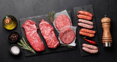 Photo for Various raw meat. Steaks, sausages, burger and spices. Flat lay - Royalty Free Image
