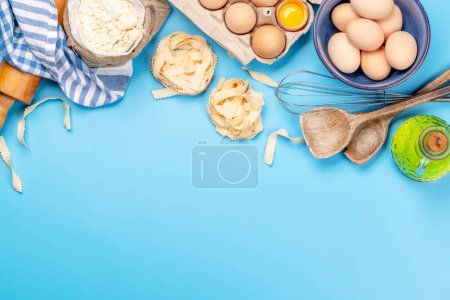 Photo for Cooking ingredients and utensils on blue background. Flat lay with copy space - Royalty Free Image
