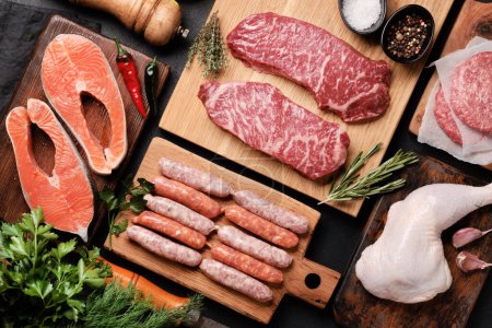 Photo for Various raw meat and fish. Steaks, sausages, salmon, chicken and spices. Flat lay - Royalty Free Image