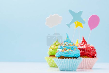 Photo for Colorful cupcakes on blue background with copy space - Royalty Free Image