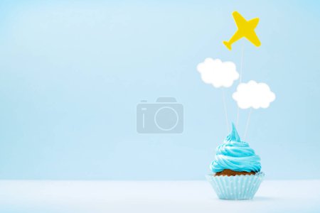 Photo for Blue cream cupcake with decor on blue background with copy space - Royalty Free Image