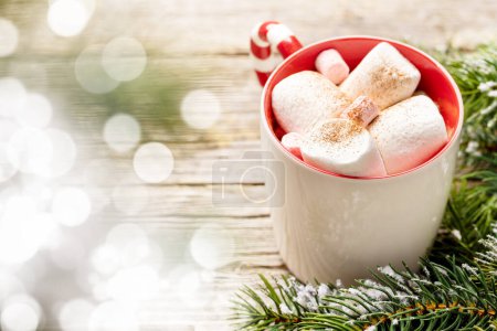Photo for Cup with marshmallow and fir tree with snow. Christmas holiday with copy space - Royalty Free Image