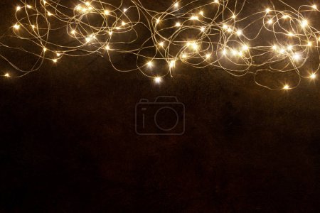 Photo for Christmas glowing garland on stone background with copy space - Royalty Free Image