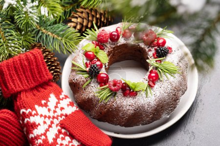 Photo for Christmas cake decorated with pomegranate seeds, cranberries and rosemary - Royalty Free Image