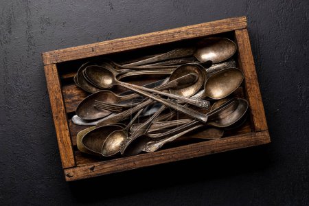 Foto de Vajilla vintage en caja de madera. Cuchara, tenedor, cuchillo. Puesta plana - Imagen libre de derechos
