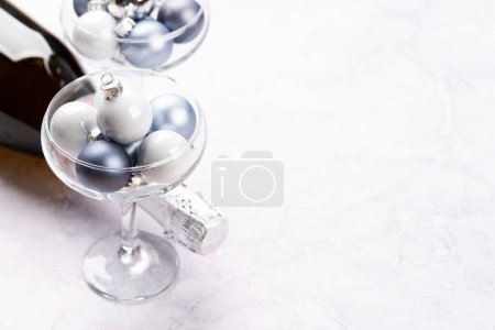 Photo for Champagne bottle, glasses with Christmas bauble balls. With copy space - Royalty Free Image