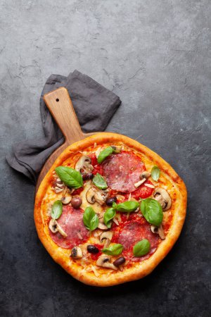 Photo for Italian cuisine. Pepperoni pizza. Flat lay on stone table with copy space - Royalty Free Image