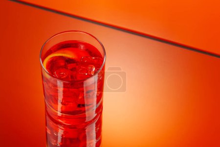 Photo for Negroni cocktail on orange background with copy space - Royalty Free Image