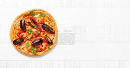 Photo for Italian cuisine. Seafood pizza. Flat lay on wooden table with copy space - Royalty Free Image