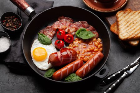 Photo for English breakfast with fried eggs, beans, bacon and sausages. Top view - Royalty Free Image