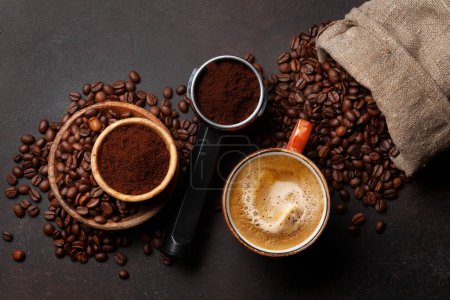Photo for Fresh cappuccino coffee, roasted coffee beans and and ground coffee in filter holder. Top view flat lay with copy space - Royalty Free Image