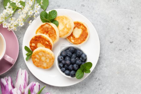 Cottage pancakes with berries. Breakfast with coffee. Top view flat lay with copy space