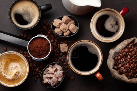 Photo for Fresh cappuccino and espresso coffee, roasted coffee beans, sugar and milk. Top view flat lay - Royalty Free Image