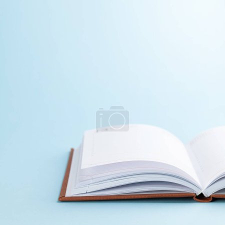 Photo for Notepad over blue background with copy space - Royalty Free Image