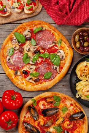 Foto de Cocina italiana. Pastas, pizza, aceitunas y tostadas antipasto. Puesta plana - Imagen libre de derechos