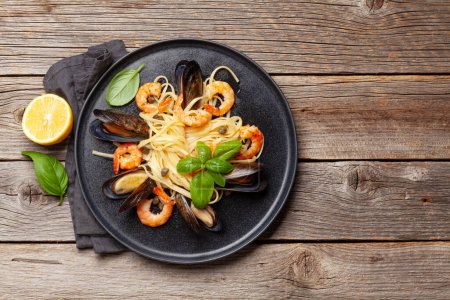 Photo for Seafood pasta with shrimps and mussels. Top view flat lay with copy space - Royalty Free Image
