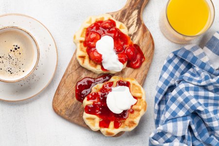 Photo for Fresh breakfast waffles with berry jam, coffee and orange juice. Top view flat lay - Royalty Free Image